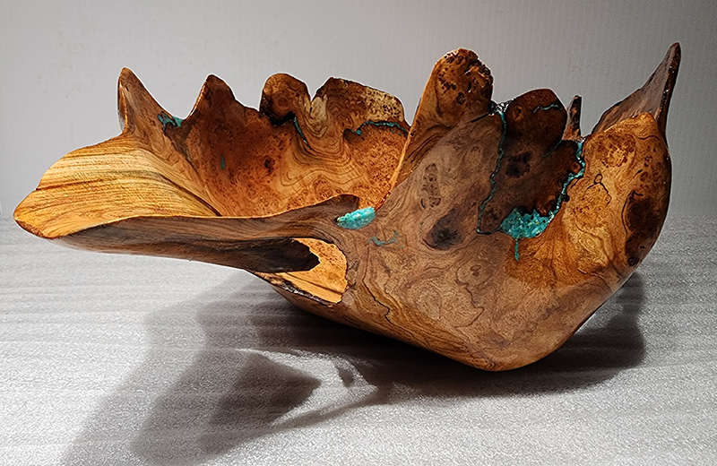 Martin uses crushed turquoise to fill the natural cracks, holes, and insect pathways in his wood products, accentuating the natural beauty of the grain and contour of his creations and bowls.