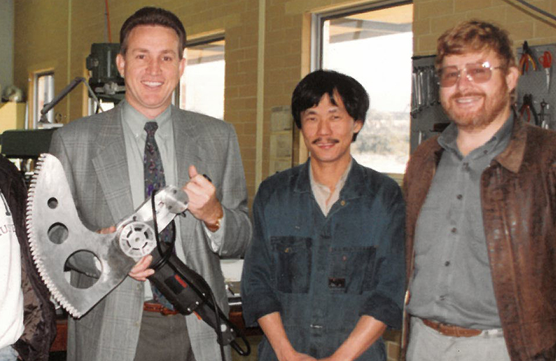 Co-founder and inventor Kevin (center) alongside the toolmakers and developers in the early 1990s.