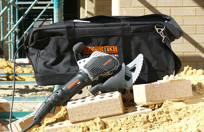 The fully evolved, commercially successful Arbortech AS170 Allsaw on-site, featuring integrated dust extraction and specialized masonry blades.